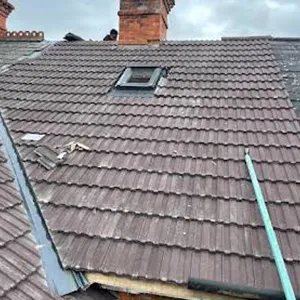 the roof of a house with a broken window