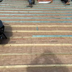 a group of people working on a roof