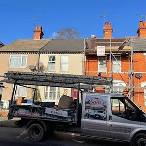 a truck parked in front of a row of houses
