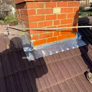 a chimney being installed on the roof of a house