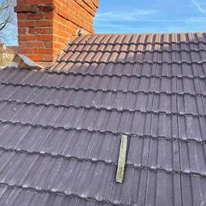 the roof of a house with a brick chimney
