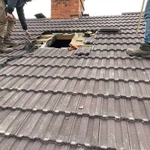 a couple of men working on a roof