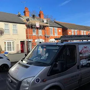 a van parked in front of a row of houses